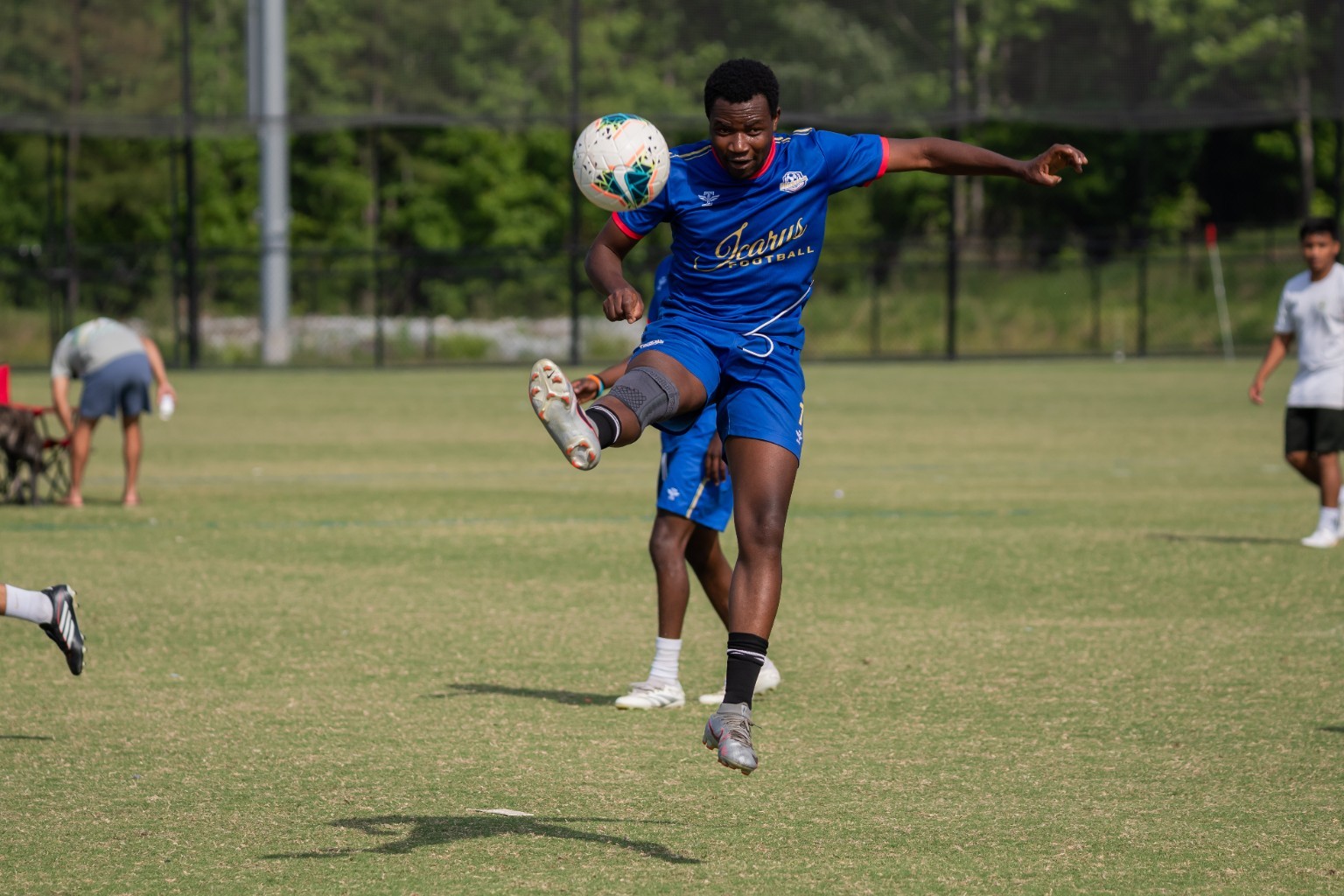 Phantom FC player striking the ball in royal blue